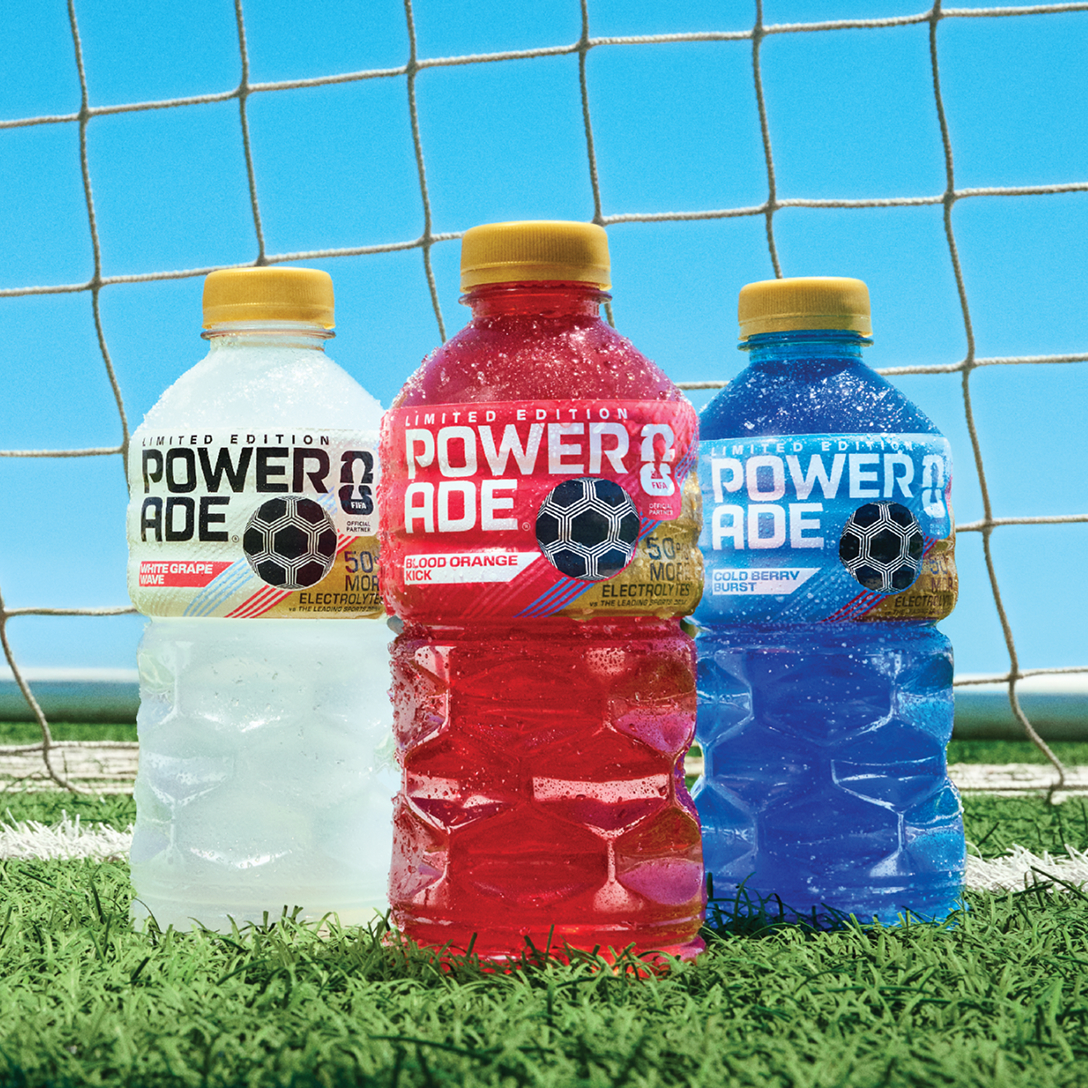Three bottles of Powerade Legacy Lineup Drinks on a soccer field